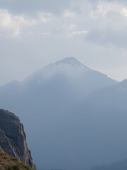 Poster - Misty mountain peak with cloudy sky.