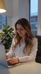 Poster - A woman is sitting at a desk with a laptop in front of her