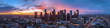 © SJarkCube - Modern cityscape of Los Angeles City with skyscrapers and highways, Los Angeles river in the background at dusk, illuminated by street lights. A Vincent Thomas bridge connecting two parts of downtown