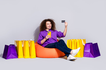 Full body portrait of pretty young woman credit card phone bags wear violet shirt isolated on grey color background