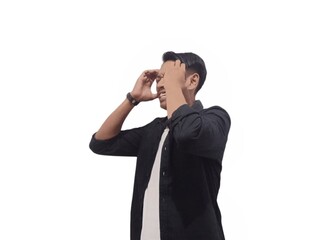 A man in a black shirt holds his head with a pained expression, indicating a headache or discomfort. The plain white background emphasizes his distress and highlights his posture and expression.