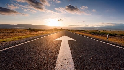 a straight road with an arrow painted on it leading to the horizon
