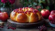 © Warakorn - A traditional holiday table featuring round challah with raisins, apples with honey, and pomegranates, arranged to celebrate Rosh Hashanah.
