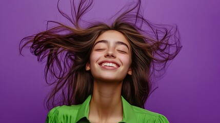 Wall Mural - Photo portrait of attractive teen woman fluttering hair dressed stylish green clothes isolated on violet color background