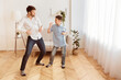 © Prostock-studio - Happy Father And Son Dancing Having Fun At Home. Little Boy And His Dad Spending Weekend Together. Copy Space