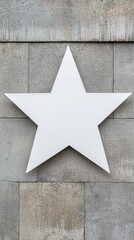 A white star is on a gray wall