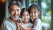 © CinimaticWorks - asian family smiling together on a gray background, a portrait of family happiness, harmony, and warmth with copy space
