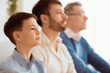 © Prostock-studio - Male Generations. Serious Boy Sitting Next To Father And Grandfather At Home. Shallow Depth