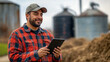 © Mattie - Happy farm technician using a tablet in the field, large scale farming and internet connectivity. Blue collar jobs, hispanic, man