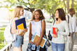 © Prostock-studio - Three multiracial girlfriends spending time at park after studying