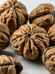 Close-up of whole walnuts in shells on a white background.