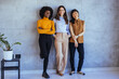 © Dragana Gordic - Three Diverse Businesswomen Standing Confidently in Office