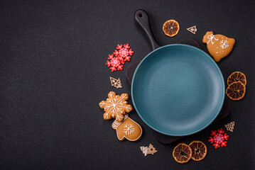 Empty round ceramic copy space plate with gingerbread cookies and Christmas elements