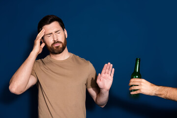 Wall Mural - Photo portrait of mature age brunet bearded funny man in beige t shirt touch head hangover headache isolated on dark blue color background