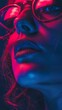 © Infinity - Close-up portrait of a woman with blue lips and red and blue light reflecting on her face.