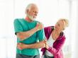 © Lumos sp - senior stretching exercise woman training sport fitness home gym exercising man couple pain shoulder injury back care health fit ache joint painful muscle backache problem medicine painful