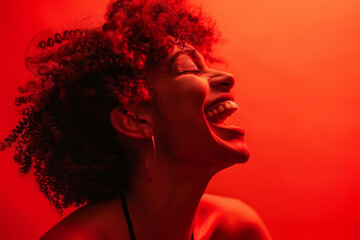 Wall Mural - A woman with curly hair is smiling and laughing