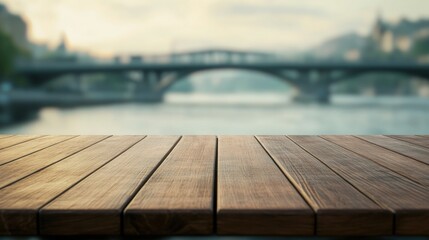 Sticker - A wooden table overlooking a blurred bridge and water scene, suggesting tranquility and leisure.