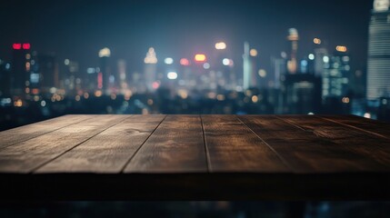 Wall Mural - A wooden table in the foreground with a blurred city skyline at night.