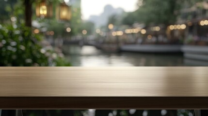 Wall Mural - A blurred riverside scene with a wooden table in the foreground, evoking a tranquil atmosphere.