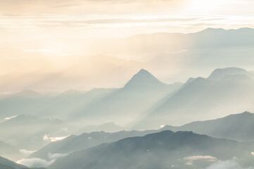 silhouettes of blue mountains in the light of dawn with perfect shapes for wallpapers and desktops in perfect harmony of freedom and calm