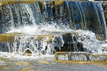 Water splashes in an artificial cascading waterfall.