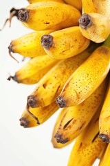 A bunch of ripe bananas hanging from a tree, great for food and decoration scenes