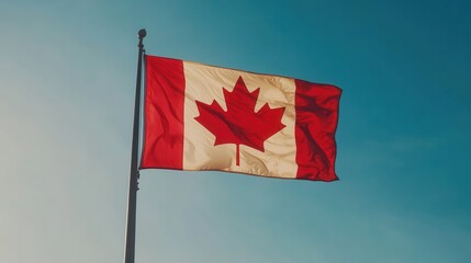 Waving Canadian flag against a clear blue sky during daylight, symbolizing national pride and unity