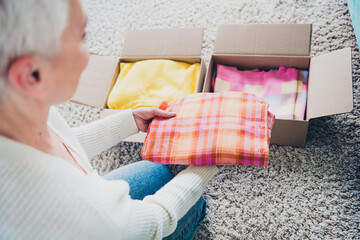 Poster - Photo of mature woman sitting floor packing parcel package order preparing relocation indoors