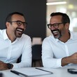 © Design@22 - Two executives laughing after intense negotiation over terms, negotiation terms, post-negotiation relief