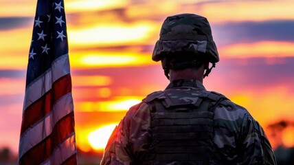 Soldier in Camouflage Uniform at Sunset with American Flag Background