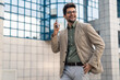 © Dorde - Smiling Businessman Interacting with Smartphone Outside