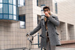© Dorde - Young Business Professional Enjoys Coffee Break Outdoors with Bicycle