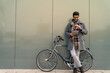© Dorde - Smiling Young Businessman with Bike and Tablet on Coffee Break