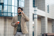 © Dorde - Energetic Young Businessman with Smartphone and Coffee Outdoors