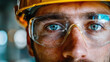 © Kitta Studio - Close up of construction workers face with safety glasses and hard hat, showcasing determination