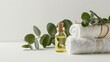 © venusvi - White towel and eucalyptus oil in a spa setting on white background Close-up photo with clean background