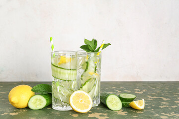 Poster - Glasses of lemonade with cucumber and mint on green table