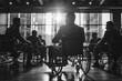 © juraj - Businessman in a wheelchair attending a meeting with his colleagues in a luminous office
