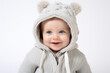 © Екатерина Ракунова - Toddler baby in a cute sweater with ears, isolated on a white studio background. Child smiling and looking away, copy space.