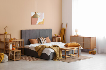 Sticker - Stylish interior of room with big comfortable bed and autumn decor