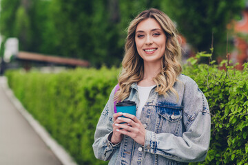 Canvas Print - Photo of nice young woman toothy smile hold coffee wear denim jacket walk city center outdoors