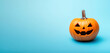 © saida - An unlit Halloween Jack O Lantern isolated on a widescreen pale blue background