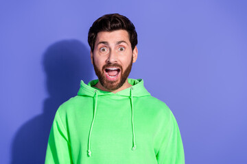 Poster - Photo portrait of handsome mature age surprised man wearing bright green hoodie sportswear isolated on violet color background