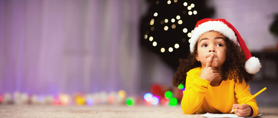 What do I want. Pensive little black girl thinking what to ask from Santa Claus, free space