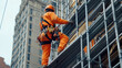 © Hound - A man in orange jumpsuit is working on a building. He is wearing a harness and is on a scaffolding