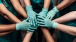 © Jirapron - A collaborative effort in healthcare with hands wearing gloves joined together, symbolizing teamwork and support in medicine.