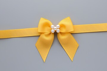 Yellow Ribbon and Bow with Pearl Accents on Light Grey Background