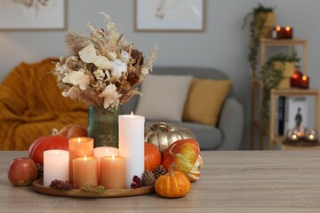 Poster - Tray with many burning candles and autumn decor on wooden table indoors. Space for text