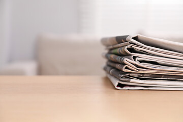 Canvas Print - Stack of newspapers in different languages on table indoors. Space for text